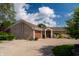 Charming ranch-style home featuring a brick facade, attached garage, and well-maintained landscaping at 9454 Raintree S Dr, Columbus, IN 47201