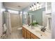 Bathroom featuring double sink vanity, mirror, tile flooring, and shower-tub combo with curtain at 11704 Gray Eagle Dr, Fishers, IN 46037