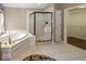 Bright primary bathroom features a soaking tub and walk-in shower at 11704 Gray Eagle Dr, Fishers, IN 46037