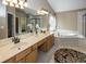 Elegant bathroom with double sinks, soaking tub, and a separate shower at 11704 Gray Eagle Dr, Fishers, IN 46037