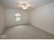 Inviting bedroom features neutral carpet, white walls, and a ceiling fan with lighting fixture at 11704 Gray Eagle Dr, Fishers, IN 46037