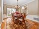 Formal dining room with hardwood floors, chandelier and view to entry at 11704 Gray Eagle Dr, Fishers, IN 46037