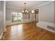 Dining room boasting gleaming hardwood floors and a chandelier at 11704 Gray Eagle Dr, Fishers, IN 46037