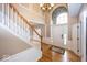 Bright foyer with hardwood floors, chandelier, staircase and grand arched window at 11704 Gray Eagle Dr, Fishers, IN 46037