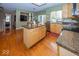 Kitchen boasts granite island, hardwood floors and stainless steel appliances at 11704 Gray Eagle Dr, Fishers, IN 46037