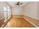 Bright living room with gleaming hardwood floors and natural light from large windows at 11704 Gray Eagle Dr, Fishers, IN 46037