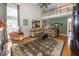 Living room with hardwood floors, sectional sofa, and views to kitchen at 11704 Gray Eagle Dr, Fishers, IN 46037