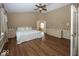 Main bedroom with hardwood floors, king-size bed, and ensuite bath at 11704 Gray Eagle Dr, Fishers, IN 46037