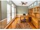 Home office with built-in shelving, hardwood floors, and large windows at 11704 Gray Eagle Dr, Fishers, IN 46037