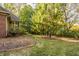 Lush backyard with manicured lawn and mature trees provide an ideal setting for relaxation and recreation at 1462 Eagle Trace Ct, Greenwood, IN 46143
