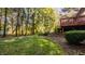Backyard with the house, wood deck, lawn, trees, landscaping, and stepping stones at 1462 Eagle Trace Ct, Greenwood, IN 46143