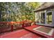 Red wood deck overlooking a lush backyard with mature trees and partial screening at 1462 Eagle Trace Ct, Greenwood, IN 46143