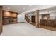 Open basement with a brick fireplace, a bar, and carpeted floors at 1462 Eagle Trace Ct, Greenwood, IN 46143