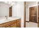 Bathroom featuring a wood vanity with marble countertop, modern fixtures, and a double door entrance at 1462 Eagle Trace Ct, Greenwood, IN 46143