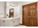 Bright bathroom featuring a double-door closet, vanity, and elegant mirror at 1462 Eagle Trace Ct, Greenwood, IN 46143