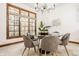 Bright dining area with a glass table, comfortable chairs, and a large window at 1462 Eagle Trace Ct, Greenwood, IN 46143