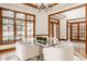 Dining room with a glass table, stylish chairs, and a view to the front entry at 1462 Eagle Trace Ct, Greenwood, IN 46143