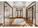 Grand foyer with hardwood floors, ornate wood trim, and a statement chandelier at 1462 Eagle Trace Ct, Greenwood, IN 46143