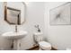 Stylish half bathroom with a pedestal sink, modern mirror and fixtures at 1462 Eagle Trace Ct, Greenwood, IN 46143