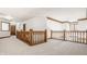 Upstairs hallway with light carpet and wood railing at 1462 Eagle Trace Ct, Greenwood, IN 46143