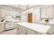 Bright kitchen featuring white cabinets, white appliances, and a large center island with bar seating at 1462 Eagle Trace Ct, Greenwood, IN 46143