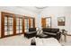 Bright living room featuring a cozy sectional sofa and a view of the kitchen at 1462 Eagle Trace Ct, Greenwood, IN 46143
