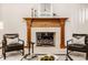 Elegant living room featuring a fireplace, mantle, and armchairs perfect for relaxing at 1462 Eagle Trace Ct, Greenwood, IN 46143