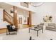 Open-concept living room featuring a staircase, pillars, and ample seating at 1462 Eagle Trace Ct, Greenwood, IN 46143