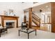 Inviting living room with a fireplace, staircase, and elegant decor at 1462 Eagle Trace Ct, Greenwood, IN 46143
