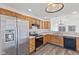 Galley kitchen with stainless steel appliances and wood cabinets at 3858 Fetlock Dr, Indianapolis, IN 46227