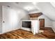 Attic space featuring hardwood floors, a ceiling fan, and a mounted TV at 545 Fletcher Ave, Indianapolis, IN 46203