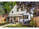 Inviting backyard with covered porch, outdoor seating, and a well-kept lawn for relaxation and entertainment at 545 Fletcher Ave, Indianapolis, IN 46203