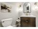 Stylish half bathroom with a dark wood vanity, decorative lighting and a modern mirror for a chic aesthetic at 545 Fletcher Ave, Indianapolis, IN 46203