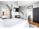 Inviting bedroom with a white bed, a mounted TV, and views into other rooms at 545 Fletcher Ave, Indianapolis, IN 46203