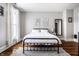 Cozy bedroom with hardwood floors, minimalist decor, and bright natural light at 545 Fletcher Ave, Indianapolis, IN 46203