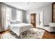 Bright bedroom with large windows, a plush rug, and exposed brick at 545 Fletcher Ave, Indianapolis, IN 46203