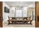 Bright dining room with a large table, bench seating, and modern lighting at 545 Fletcher Ave, Indianapolis, IN 46203