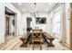 Stylish dining room featuring a wooden table, benches, and contemporary chandelier at 545 Fletcher Ave, Indianapolis, IN 46203
