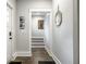 Bright hallway featuring wood floors, stairs and an decorative wall mirror, adding a touch of modern elegance at 545 Fletcher Ave, Indianapolis, IN 46203