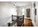 Elegant hallway with hardwood floors, dark wood railing, and stylish decor at 545 Fletcher Ave, Indianapolis, IN 46203
