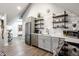 Modern kitchen with stainless steel appliances, white subway tile backsplash, and wooden shelving, a chef's dream at 545 Fletcher Ave, Indianapolis, IN 46203