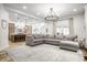 Spacious, open-concept living room with a large sectional sofa that is next to an open kitchen at 545 Fletcher Ave, Indianapolis, IN 46203