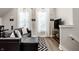 Cozy living room with leather seating, decorative rugs, and abundant natural light at 545 Fletcher Ave, Indianapolis, IN 46203