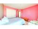 Simple bedroom with a single bed and pink walls at 7821 Valley Stream Dr, Indianapolis, IN 46237