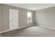 Neutral bedroom with plush gray carpet, a door, and a window with a neighborhood view at 20326 N Pacific Ave, Westfield, IN 46074