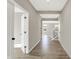 Bright hallway featuring hardwood floors, a staircase, and doorways leading to other rooms in the home at 20326 N Pacific Ave, Westfield, IN 46074