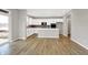 Well-lit modern kitchen featuring white cabinets, stainless steel appliances, island, and hardwood floors at 20326 N Pacific Ave, Westfield, IN 46074