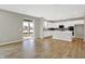 Open concept kitchen featuring an island, white cabinets, stainless steel appliances, and hardwood floors at 20326 N Pacific Ave, Westfield, IN 46074