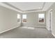 Spacious main bedroom featuring neutral carpeting, tray ceiling, and large windows at 20326 N Pacific Ave, Westfield, IN 46074