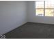 Spacious bedroom with a large window and grey carpet at 3912 Highcrest Rd, Indianapolis, IN 46239